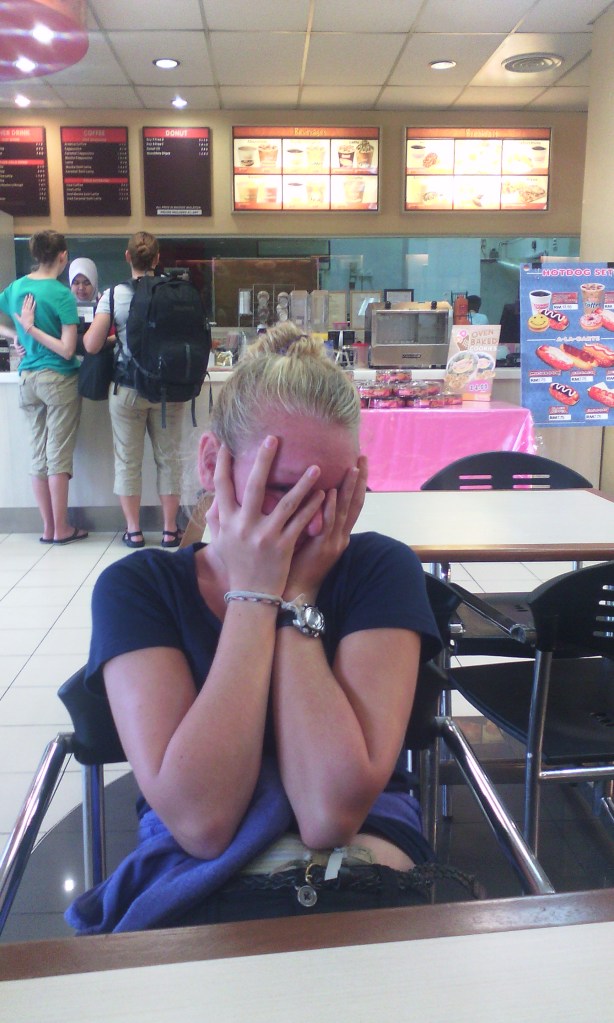 Arwen refusing to have her picture taken while Kali and I order Doughnuts in JB, Malaysia