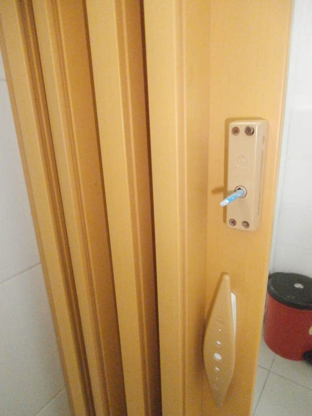 Bathroom door with rolled up paper fix